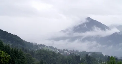 Low hanging clouds floating over over mountains in Austria, panning shot Stock Footage 79761280
