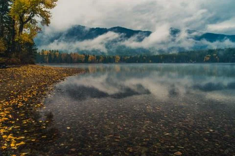 Low hanging clouds reflected in a lake. Stock Photos