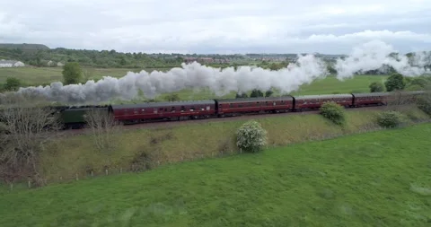 Low high to left tracking aerial shot of the Flying Scotsman steam train Video stock 169062498