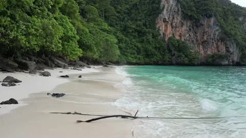 A low, intimate drone flyby along the shoreline of Monkey Beach, Koh Phi Phi Stock Footage 300432211