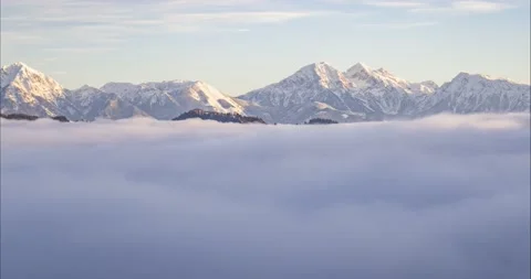 Low inversion clouds moving in alpine valley Stock Footage 166879601