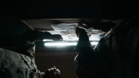 Low Key of Commanders Discussing Military Plan by Board in Command Center Stock Footage 301672255