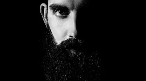 Low key dramatic photo of a bearded man Stock Photos