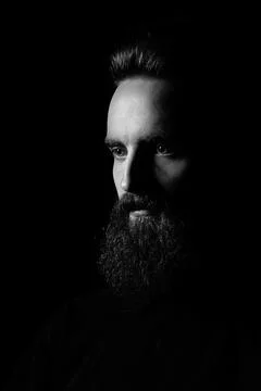 Low key dramatic photo of a bearded man Stock Photos