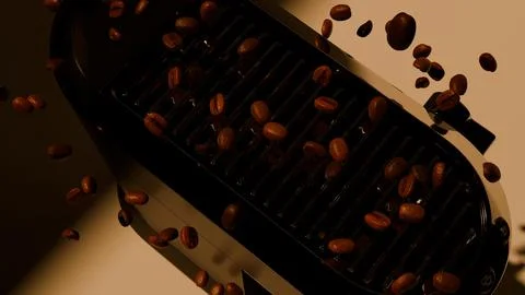 Low key espresso machine with flying coffee beans and warm highlights Stock Photos