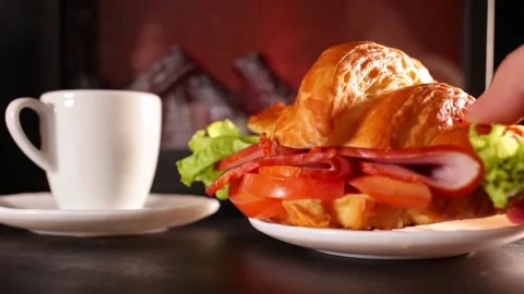 Low key, hot tea white cup, saucer. Beautiful croissant with tomatoes, meat Stock Footage 149000950