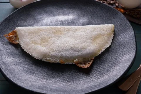 Low key Melted mozzarella cheese tapioca, next to a cup of black coffee blu.. Stock Photos