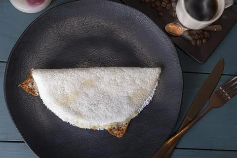 Low key Melted mozzarella cheese tapioca, next to a cup of black coffee blu.. Stock Photos
