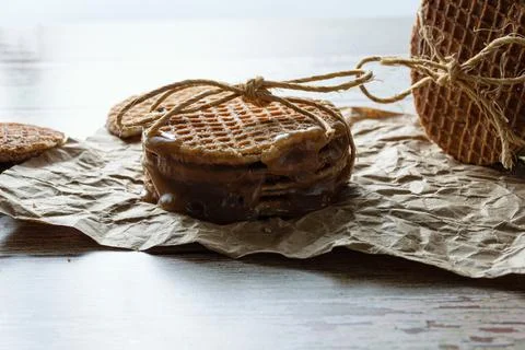 Low key photography. Closeup of a stack of stroopwafels with a sisal bow, nex Stock Photos