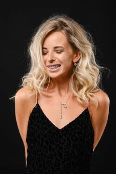 Low key portrait of cute young woman with curly hair in black dress Foto stock
