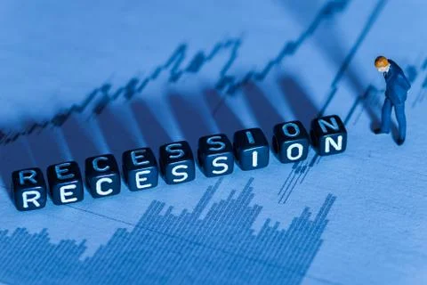 Low key selective focus miniature figurine and word block 'Recession' concept Fotos Stock