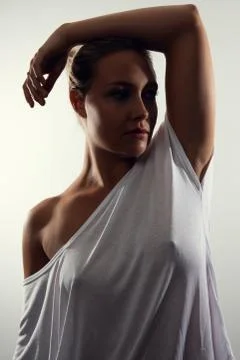 Low-key studio portrait of gorgeous woman with blonde hair and white t-shirt Stock Photos