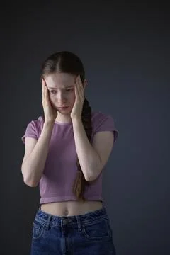 Low Key Studio Portrait Of Stressed Teenage Girl Worried About Mental Healt.. Stock Photos