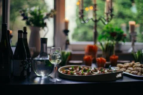 Low key table set in hip apartment for snacks Stock Photos