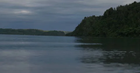 LOW TO LAKE WITH POINT IN DISTANCE Stock Footage 230996675