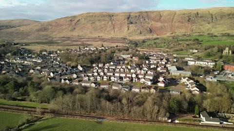 Low level aerial footage over the rural village of Lennoxtown. Stock Footage 304241618