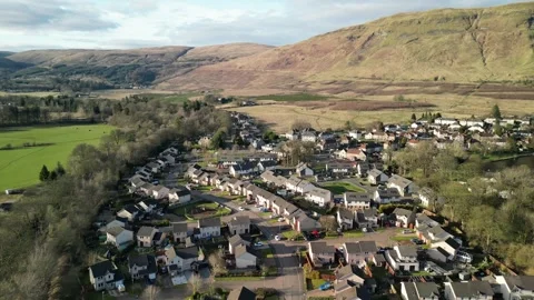 Low level aerial footage over the rural village of Lennoxtown. Stock Footage 304241637