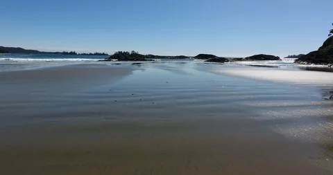 Low-level Aerial Push Shot from beach moving out over waves (2 of 2) Stock Footage 106849323