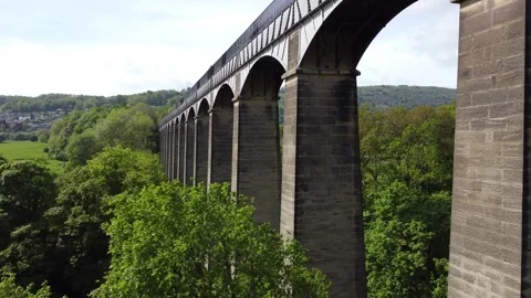 Low level aerial of the stone piers and iron arches of Pontcysyllte Aqueduct Video stock 346228918