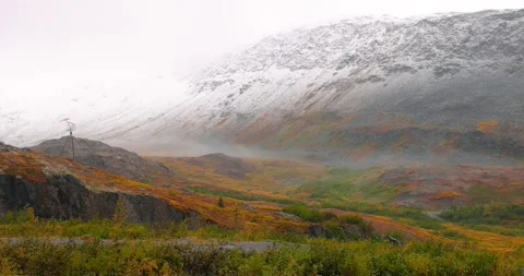 Low level clouds and fog on snow covered mountains in Alaska tundra landscape Stock Footage 322198443
