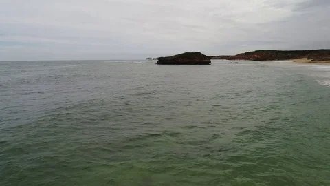 Low level drone along water and coastline Stock Footage 84308111