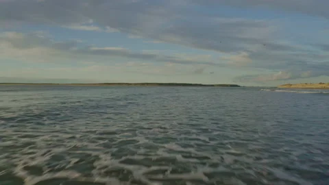 Low level drone suck back across ocean Stock Footage 167427722