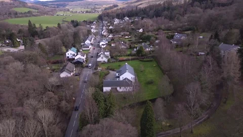 A low level flight along the main street of a picturesque village in Scotland. Stock Footage 331606131