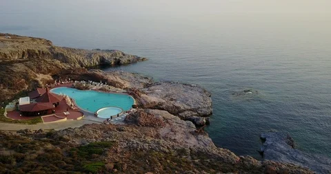 Low Level Flight Over Pool on the Sea Sardinia / Italy Stock Footage 88035489