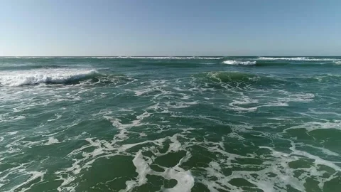 Low level flight over water surface, breaking waves Stock Footage 170946620