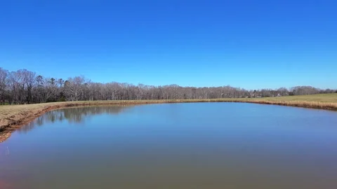 Low Level Flight Towards A Pond And Back To Shore Stock Footage 296992025
