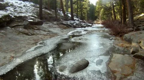 Low level icy creek flyover Stock Footage 11583386