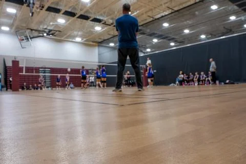 Low level selective focus on gym floor at a youth volleyball match Stock Photos