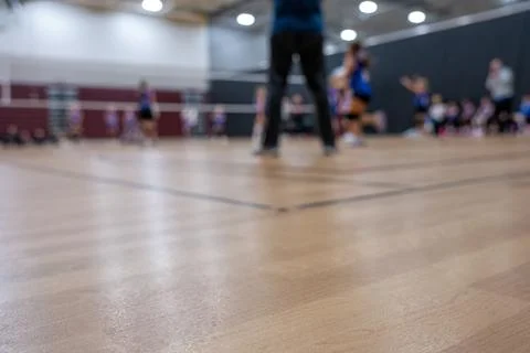 Low level selective focus on gym floor at a youth volleyball match Foto stock