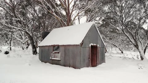 Low Level Zoom Into Snow Covered High Country Hut 4K Aerial Stock Footage 136719514