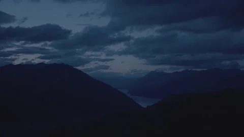 Low light aerial of clouds, mountains and lake Stock Footage 155453501