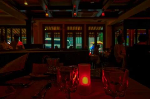 Low light scene at a candle light table in a New York restaurant. Stock Photos