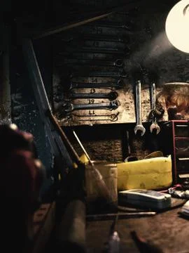 Low light workbench with wrench tools in focus Stock Photos