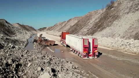 Low loader truck delivering container in remote area. Transportation concept Stock Footage 205399293