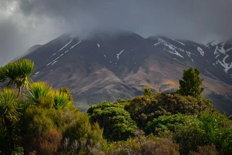 Low lying cloud shrouds Mount Taranaki, New Zealand. Dramatic dark skies. 写真素材