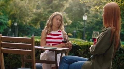 A low more distant angle of a stunning blonde lady with her ginger haired friend Stock Footage 160978530