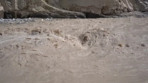 Low Motion of Flooded Mountain Stream Flowing Rapidly Stock Footage 308962514