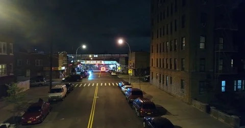 Low Night Aerial Gliding Down Bronx Street Toward Elevated Train Stock-Footage 76908632