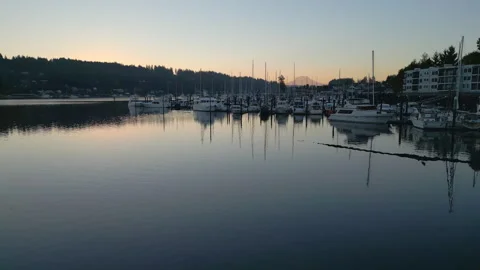 Low orbit over the bay towards docked boats in Gig Harbor, Washington Stock Footage 304269478