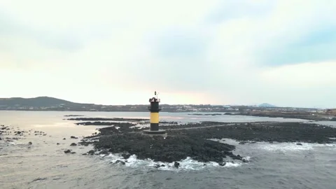 Low Orbiting View of Udo Island around a Lighthouse, Udo-biyangdo. Late Evening. Stock Footage 146067146