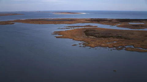 Low over water and marshy islands, crossing Little Egg Inlet, New Jersey. Shot Stock Footage 59219928