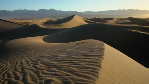 Low pan to a sandy foreground in a large dune field. Stock Footage 154973021
