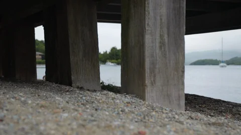 Low Pan shot on the beach near the pier Stock Footage 100560985