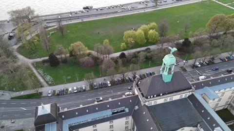 Low pass above riverside building with eagle sculpture Stock Footage 331198667