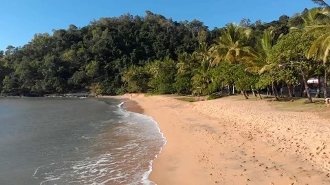 Low pass flight along an empty beach at Sunrise, Cairns, Australia, 4K 動画素材 106810358