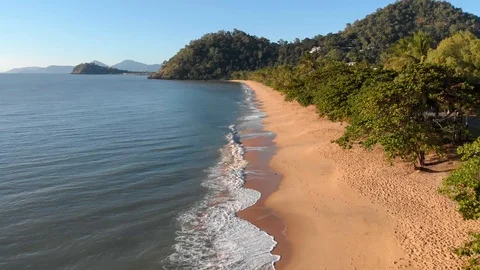 Low pass flight along an empty beach at Sunrise, Cairns, Australia, 4K Stock Footage 106823857